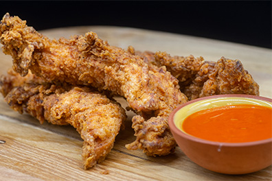 Chicken Tenders near West Berlin, New Jersey served with Hot and Honey Buffalo dipping sauce.