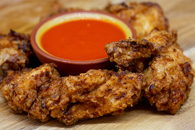 Chicken Bites with dipping sauce prepared at our chicken place near Cherry Hill, New Jersey.