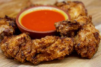 Chicken Bites with dipping sauce prepared at our chicken place near Maple Shade, New Jersey.